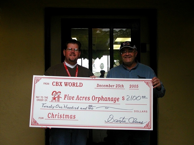 Tim & George proudly display the check presented to the orphanage.